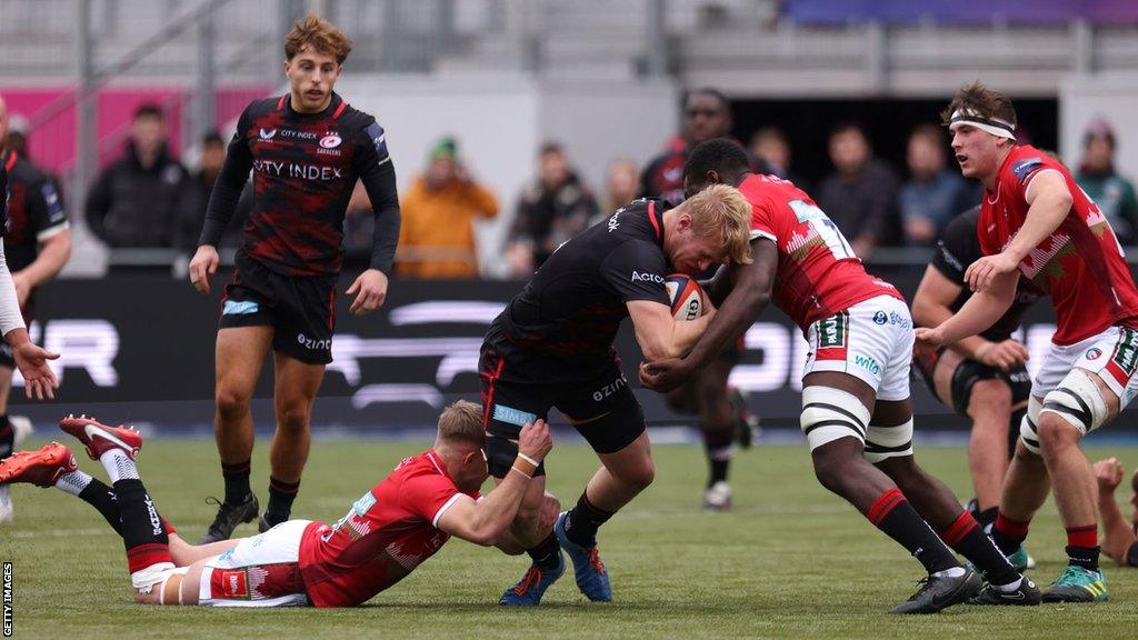 Nathan Michelow of Saracens is tackled with the ball