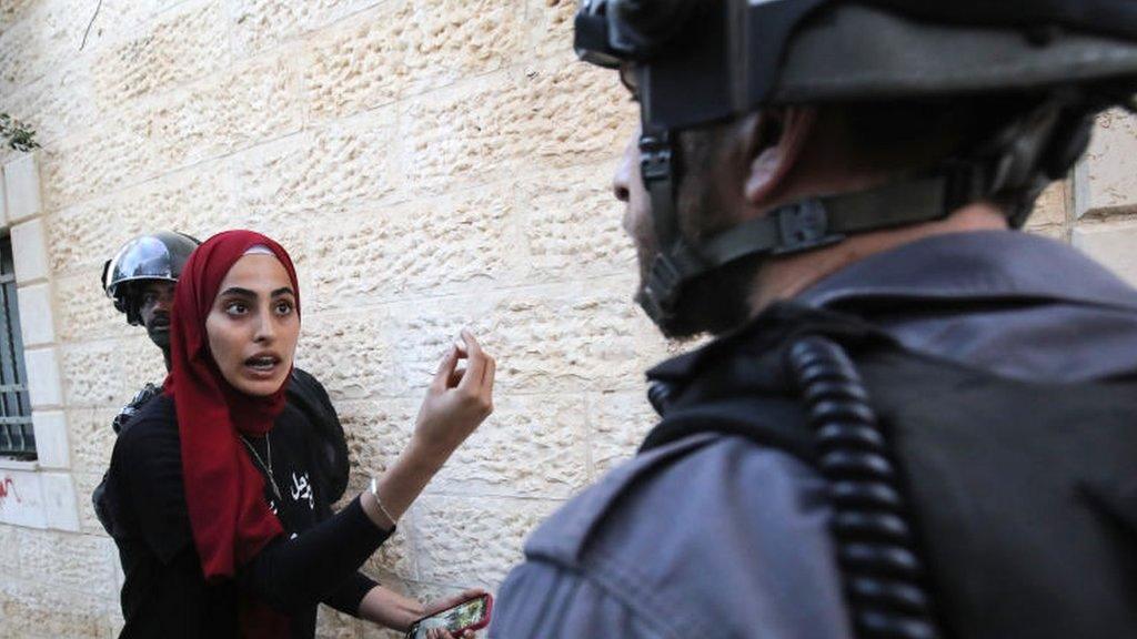 Palestinian woman argues with Israeli policeman