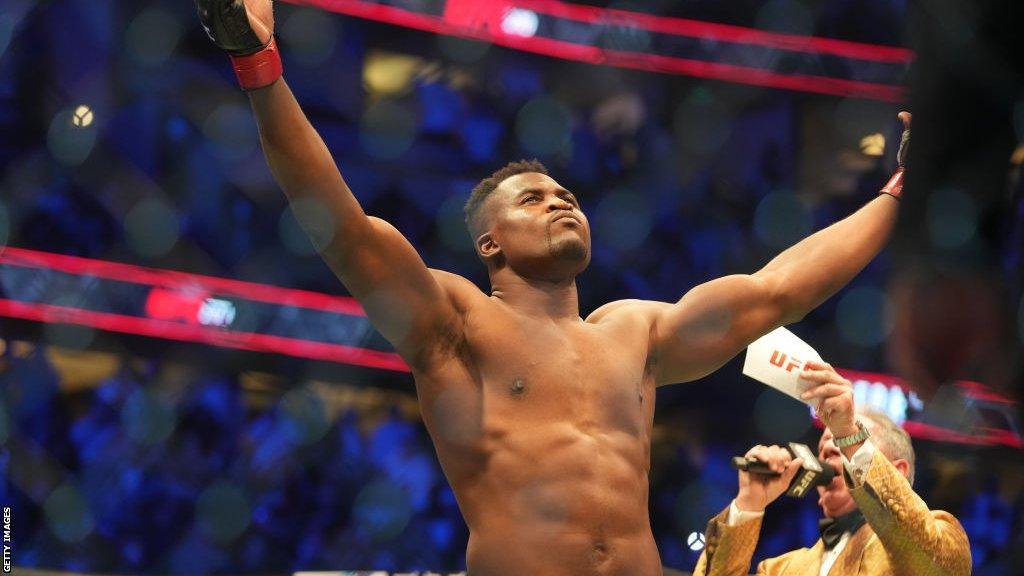 Francis Ngannou raises his arms up to the crowd