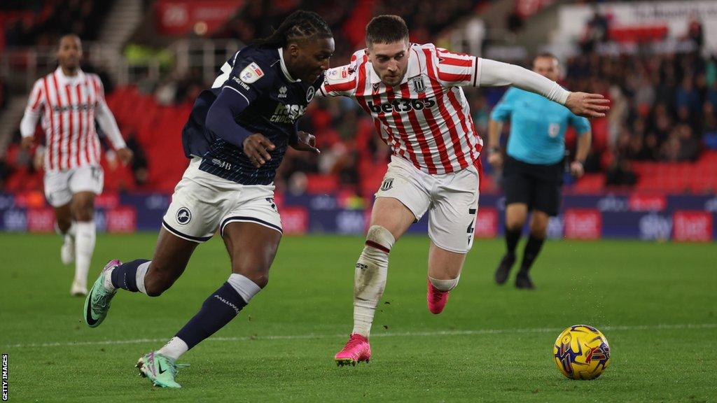 Brooke Norton-Cuffy of Millwall (left)takes on Stoke City's Lynden Gooch