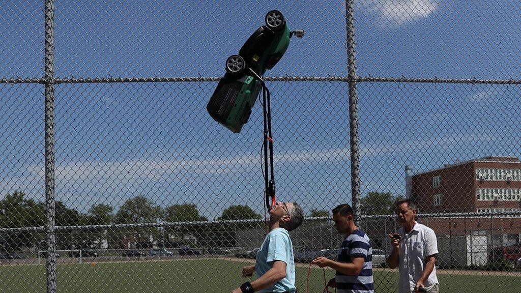 Ashrita Furman carrying a lawnmower on his chin