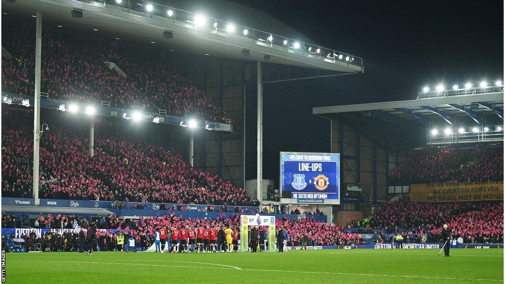 Fans holding up protest cards at Goodison Park