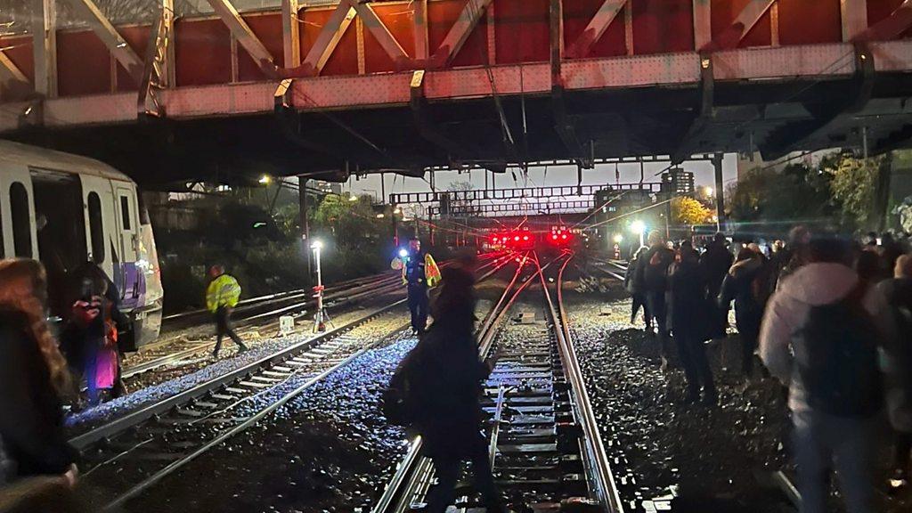 People walking down train tracks