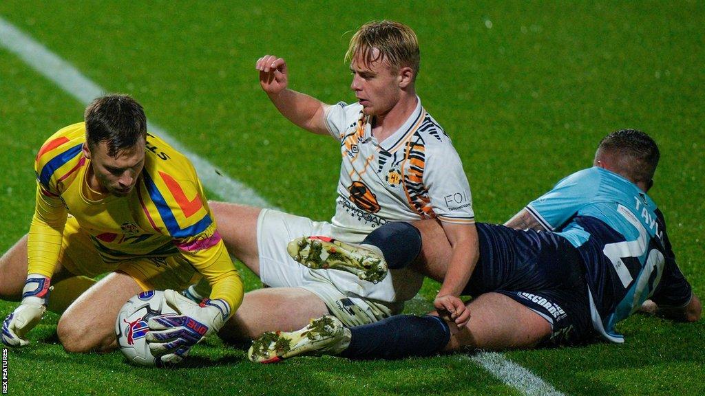 Jack Stevens saves from Wycombe's Dale Taylor