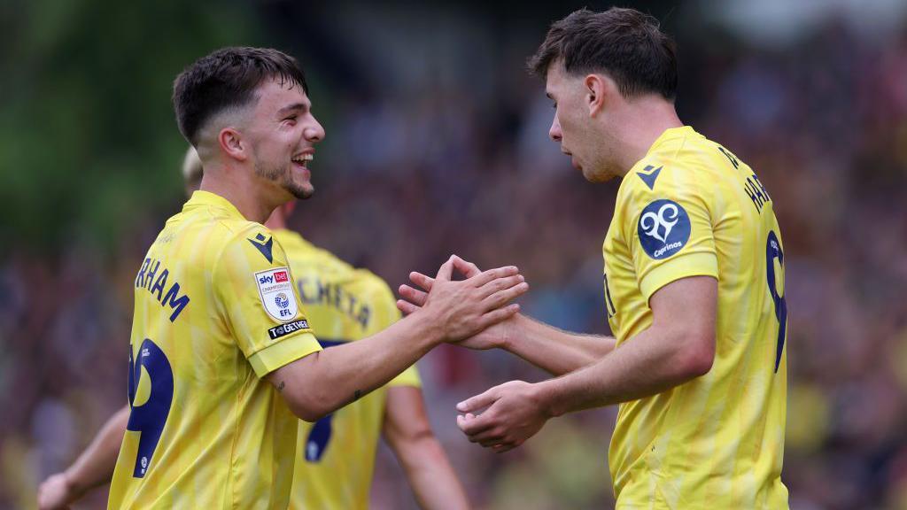 Mark Harris of Oxford United celebrates with Tyler Goodrham after scoring during the Championship match between Oxford United FC and Norwich City FC