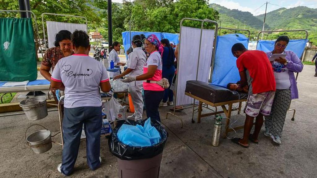 Rescue workers and paramedics set up a makeshift care centre in Moron, Carabobo State