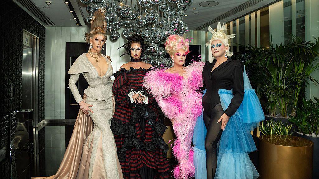 Silllexa Dixon wearing a cream and green dress, Bones wearing a black and red dress, Elle Vosque wearing a pink and black dress and Catrin Feelings wearing a black and blue dress.