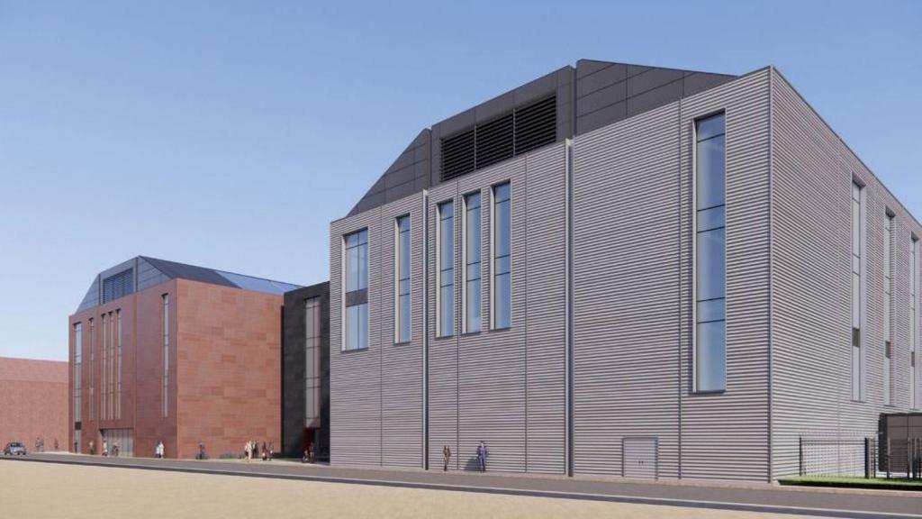 An impression of what the facility will looks like, a large grey building with a smaller brown one next to it.