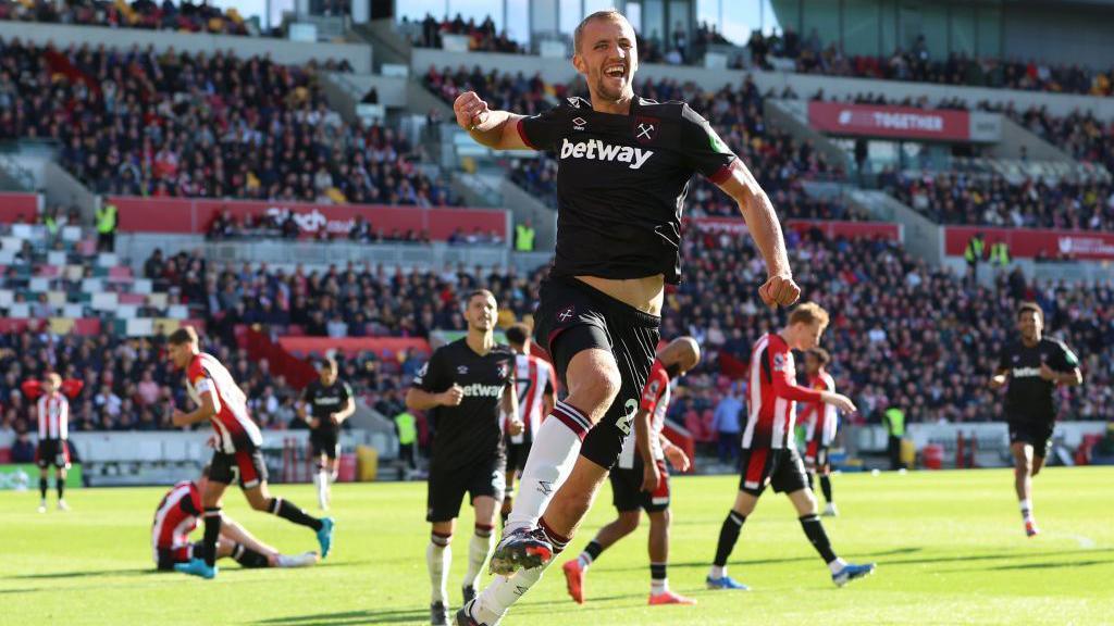 Tomas Soucek jumps in the air after scoring a goal