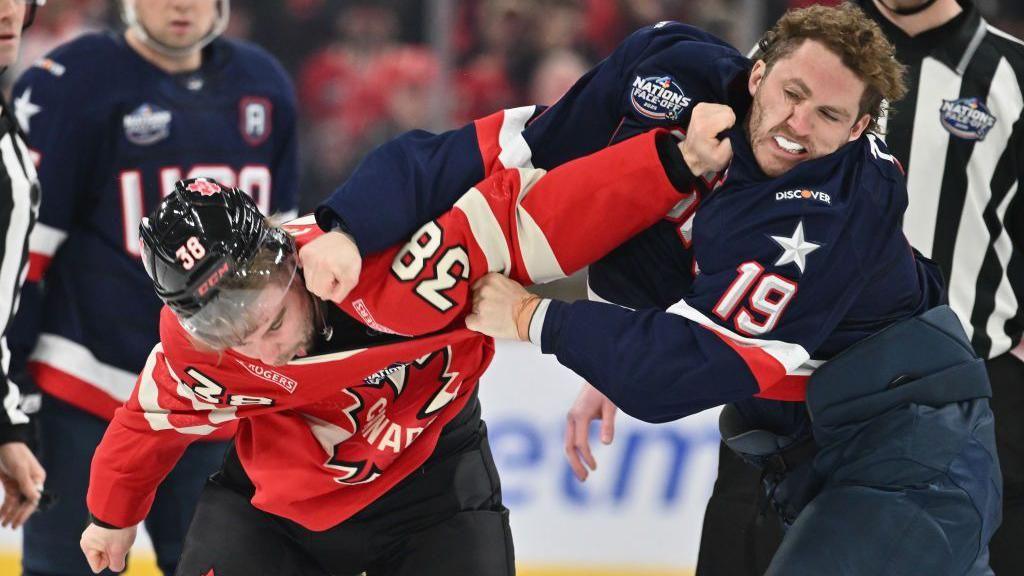 Canada's Brandon Hagel and US player Matthew Tkachuk fighting during their ice hockey match