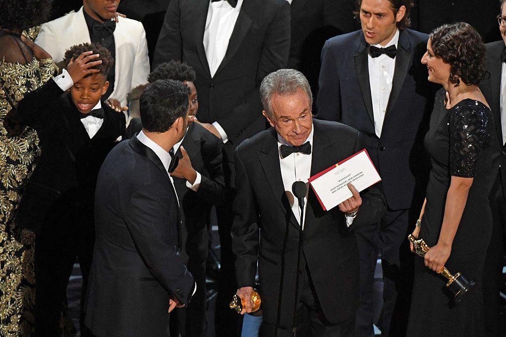 The cast of "Moonlight" and ""La La Land" appear on stage as presenter Warren Beatty shows the winner's envelope at the Oscars.