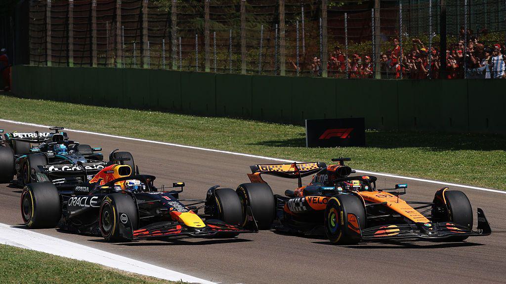 Red Bull's Max Verstappen moves alongside Oscar Piastri to pass him at the start of the Emilia-Romagna Grand Prix