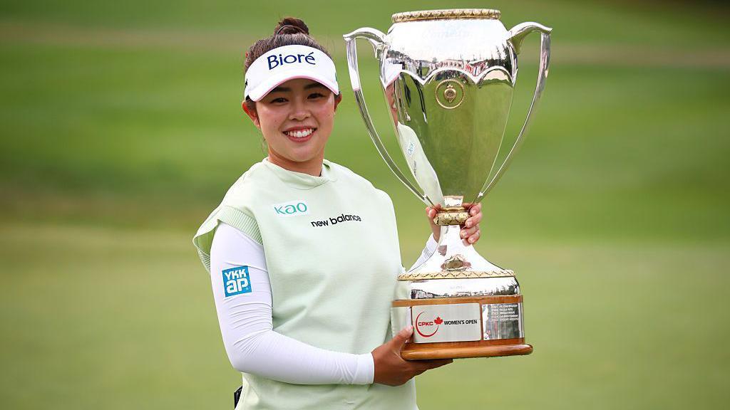 Miyu Yamashita of Japan celebrates with the trophy after winning the CPKC Women's Open 2026 at Royal Mayfair Golf Club