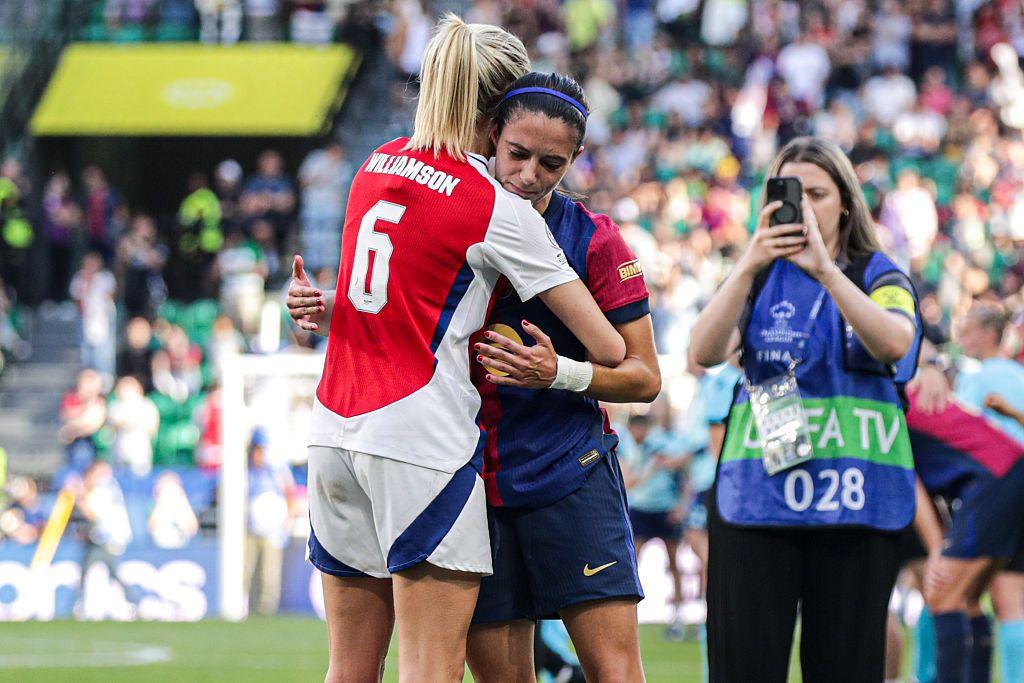 Leah Williamson of Arsenal Women FC consoles Aitana Bonmati of FC Barcelona.