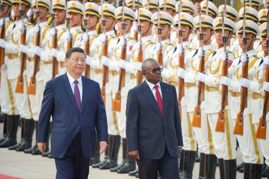 Umaro Sissoco Embalo, the president of Guinea-Bissay, inspects troops at the Great Hall of People in Beijing. Walking next to him is China's President Xi Jinping.