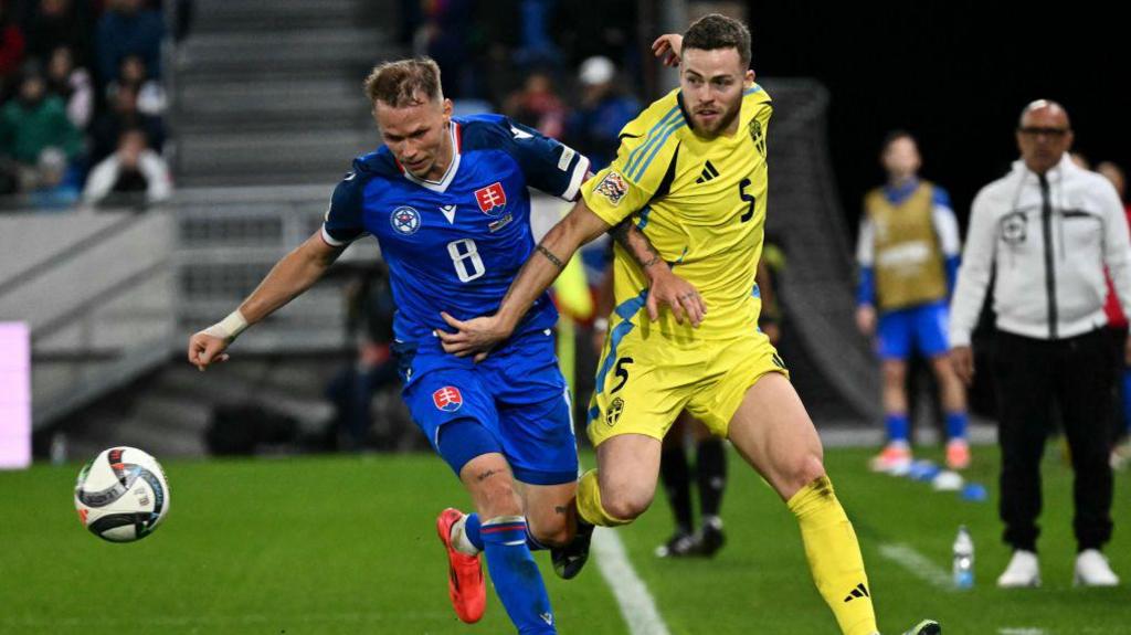 Ondrej Duda (L) and Sweden's defender Gabriel Gudmundsson challenge for the ball