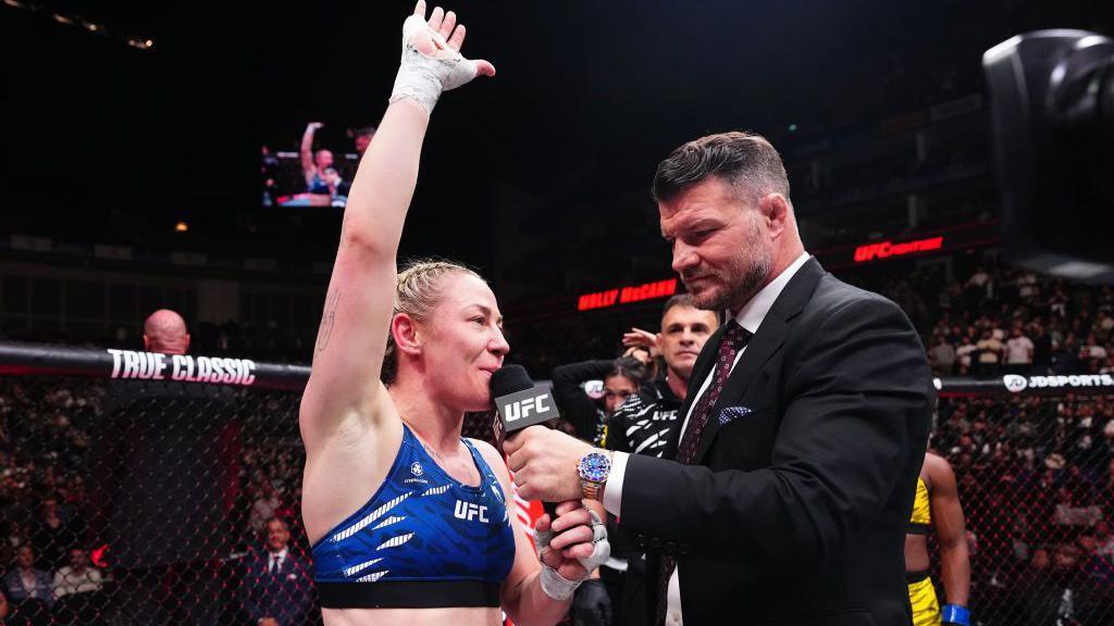 Molly McCann waves to the fans after a UFC fight