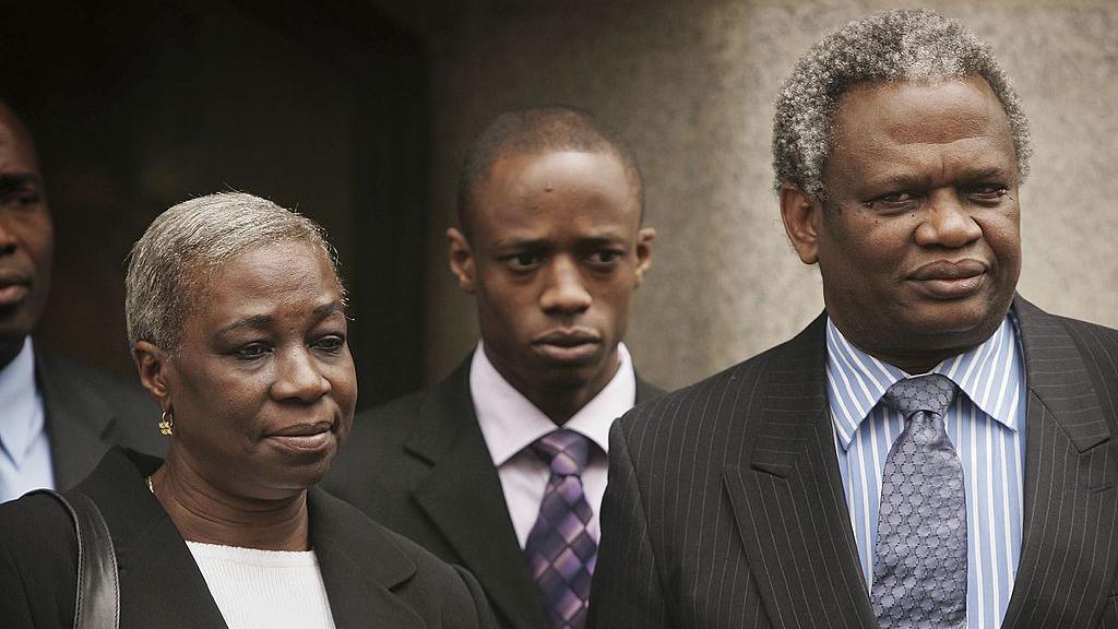 Gloria, Tunde and Richard Taylor outside the Old Bailey in April 2006. All three wear dark coloured suits.