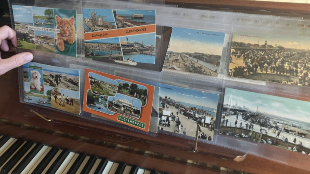 Collection of old postcards on a piano