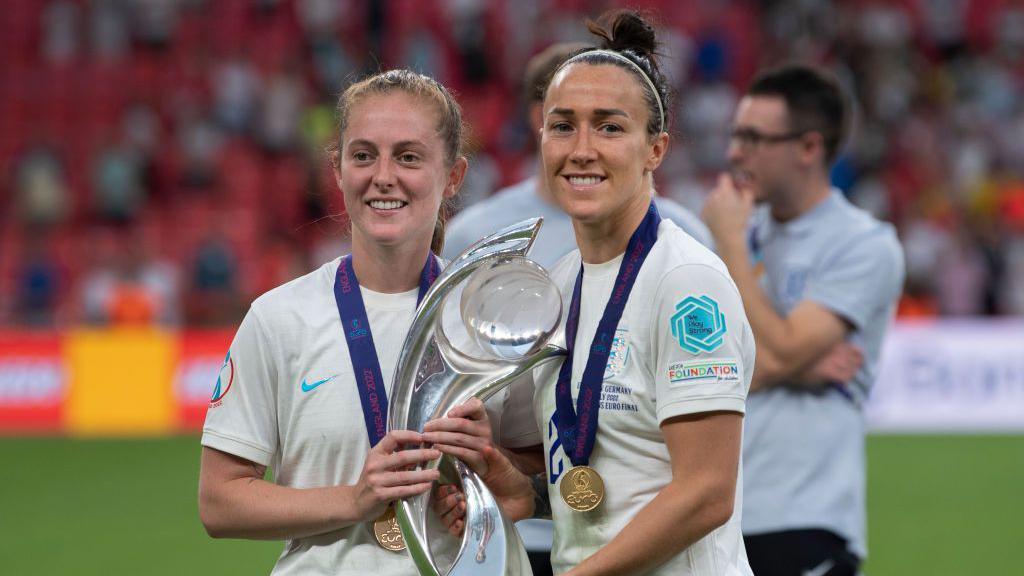 Keira Walsh and Lucy Bronze of England with the trophy after the UEFA Women's Euro England 2022 final match between England and Germany at Wembley Stadium