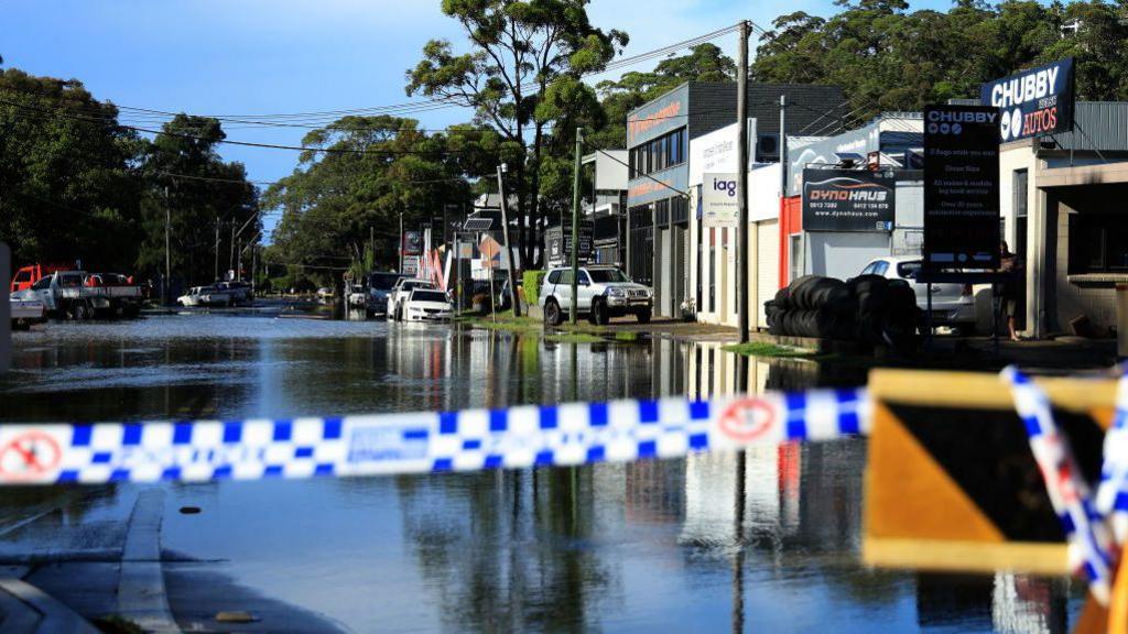 A flooded road is seen in the Sydney suburb of North Narrabeen on April 6, 2024, after heavy rain hit New South Wales state.