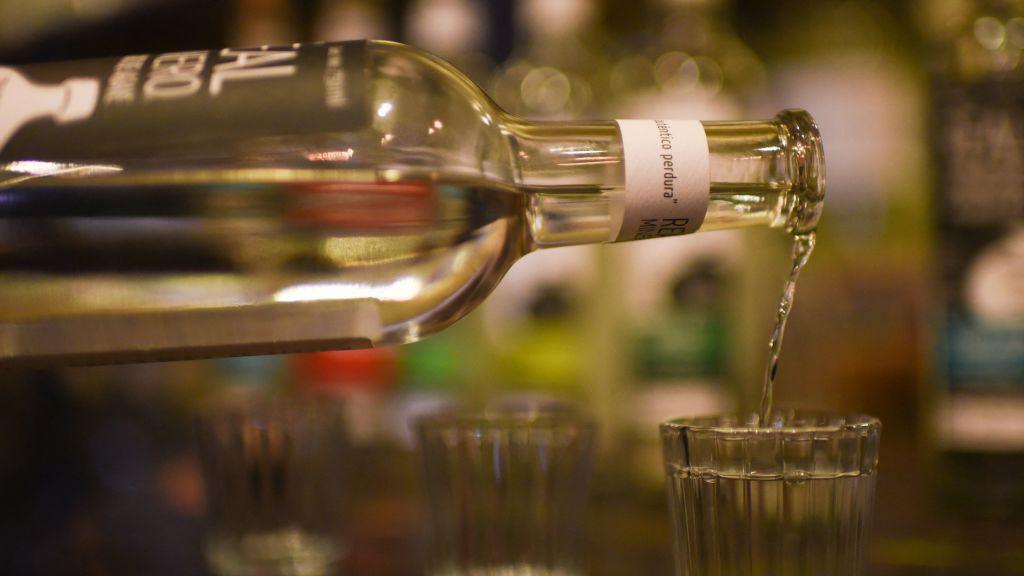 Bottle of mezcal being poured