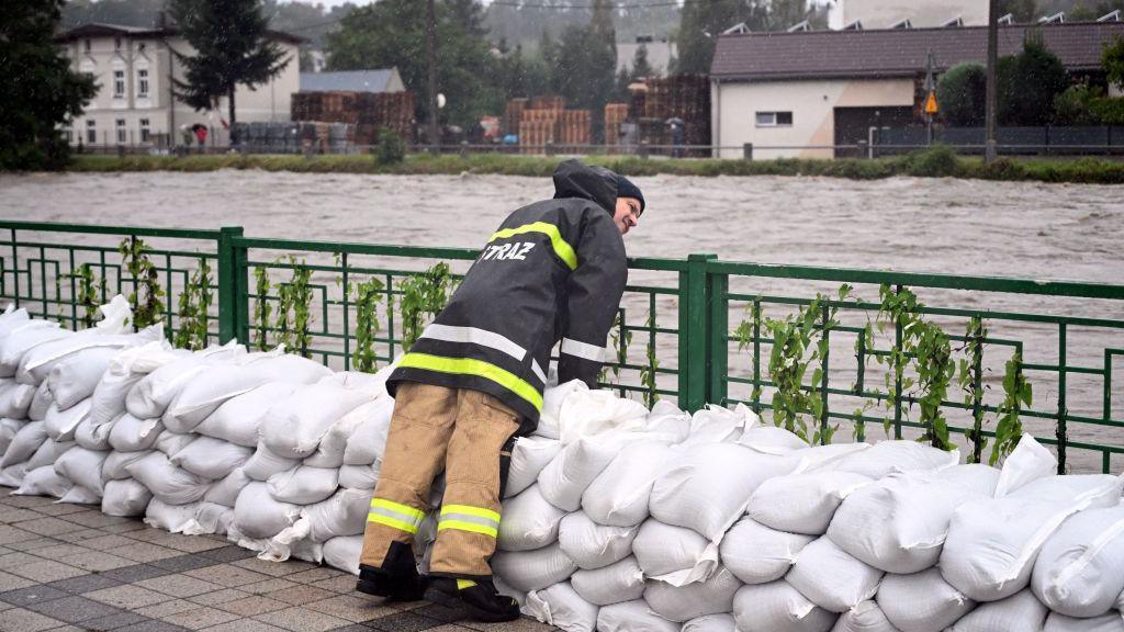 Firefighter building sandbag barriers