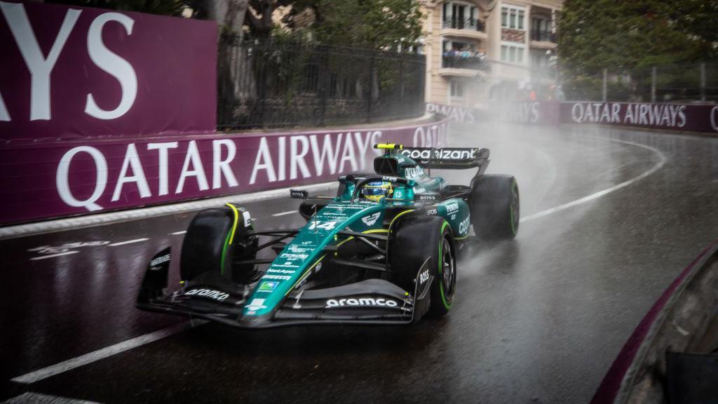 Fernando Alonso approaches the chicane following the tunnel in his Aston Martin in the wet at the 2023 Monaco Grand Prix