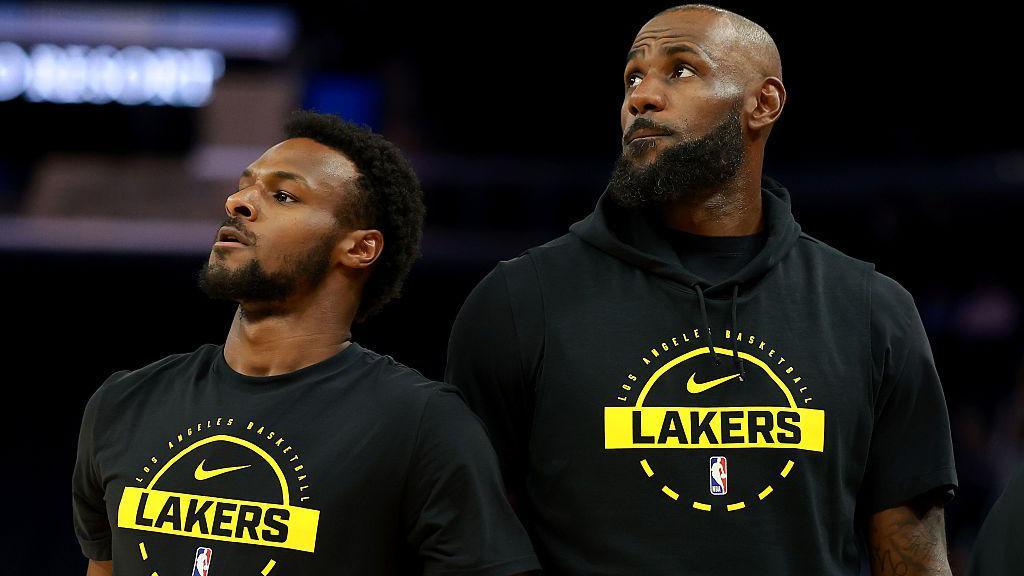 LeBron James of the Los Angeles Lakers walks past his son, Bronny James #9, before their game against the Golden State Warriors at Chase Cente