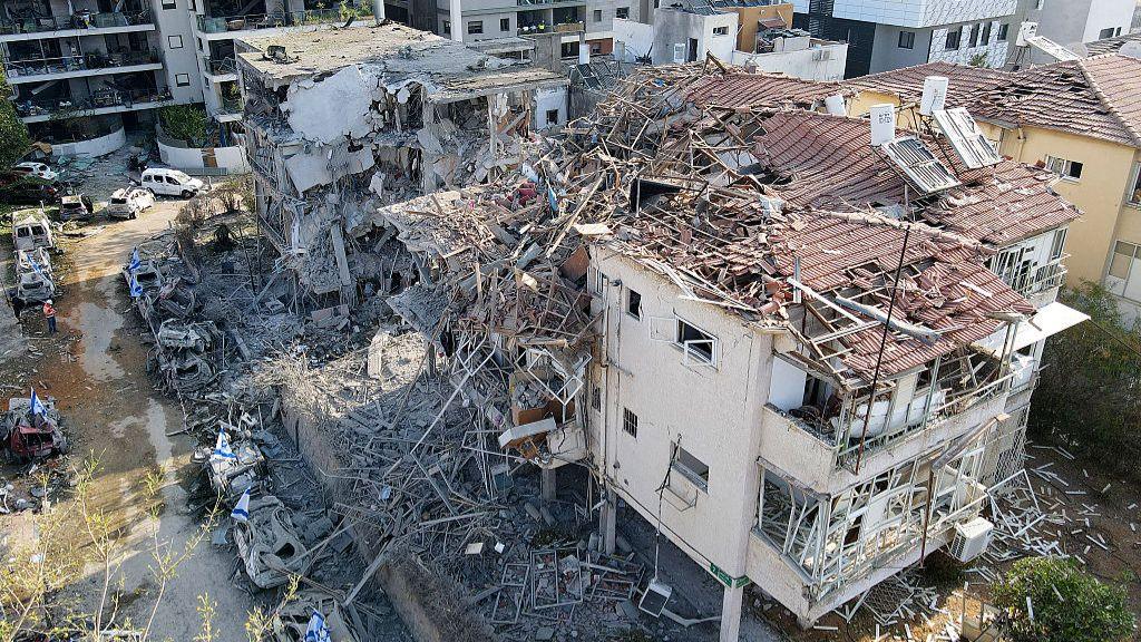 This aerial picture shows damaged buildings at a site hit by a missile fired from Iran in the Israeli city of Ramat Gan near Tel Aviv on June 14, 2025.