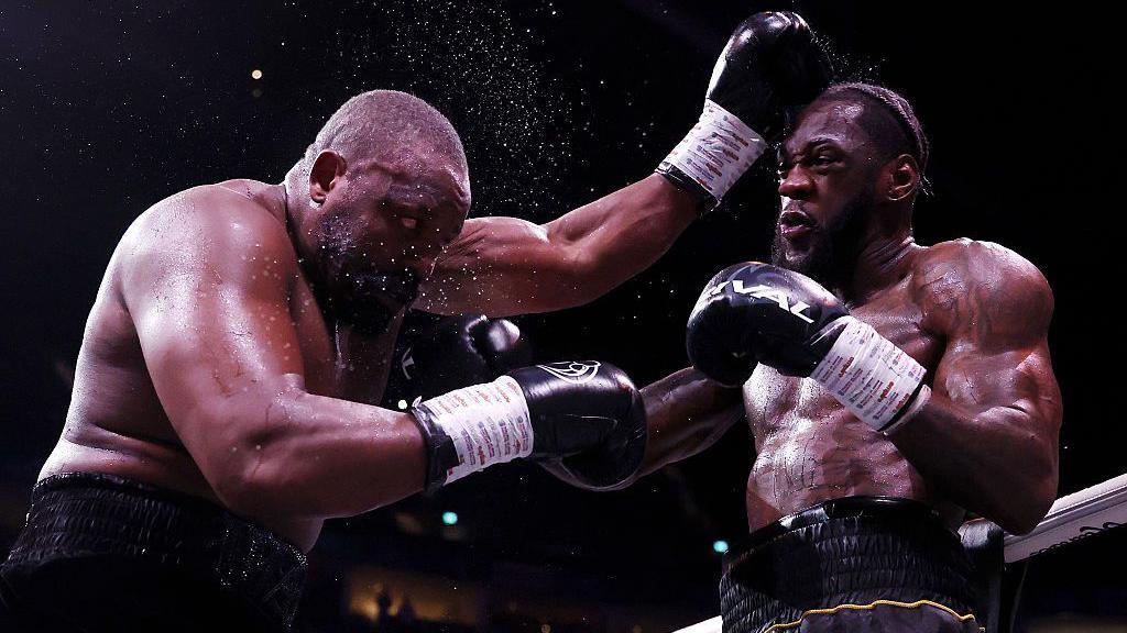 Derek Chisora is punched by Deontay Wilder