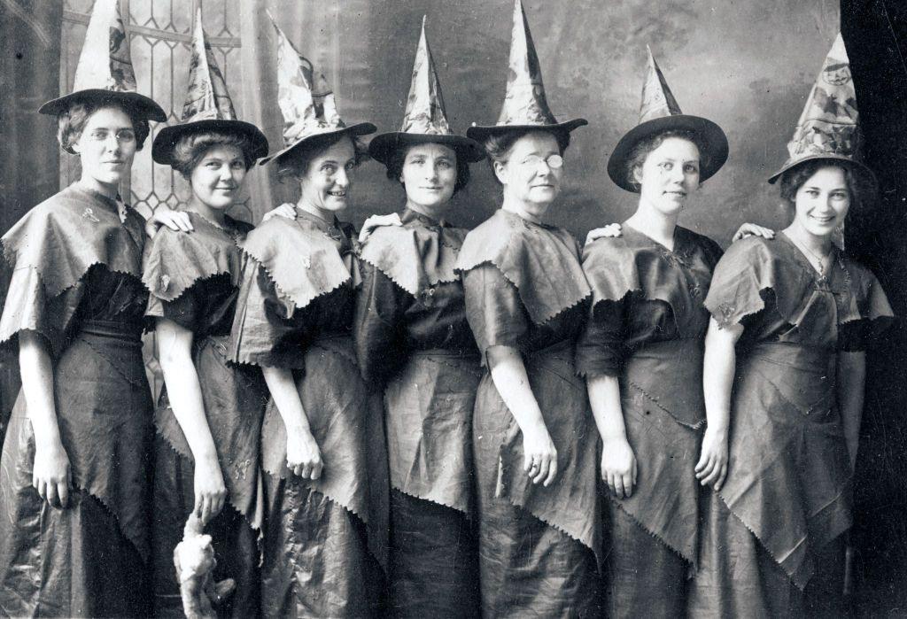 an archive photo of a line of women dressed as witches