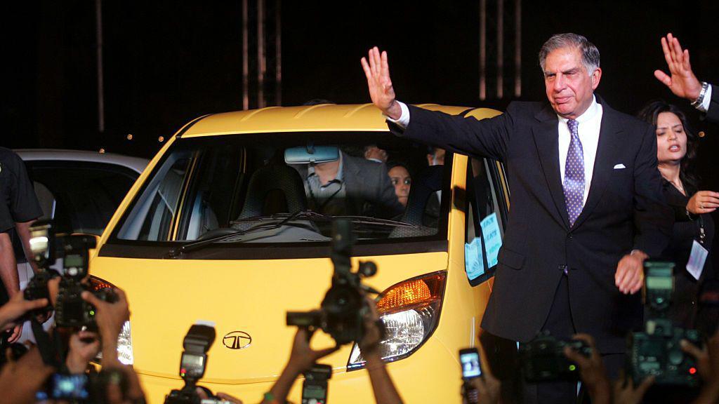 Tata Sons Chairman - Ratan Tata poses alongside the Tata Nano at its launch in Mumbai on Monday.