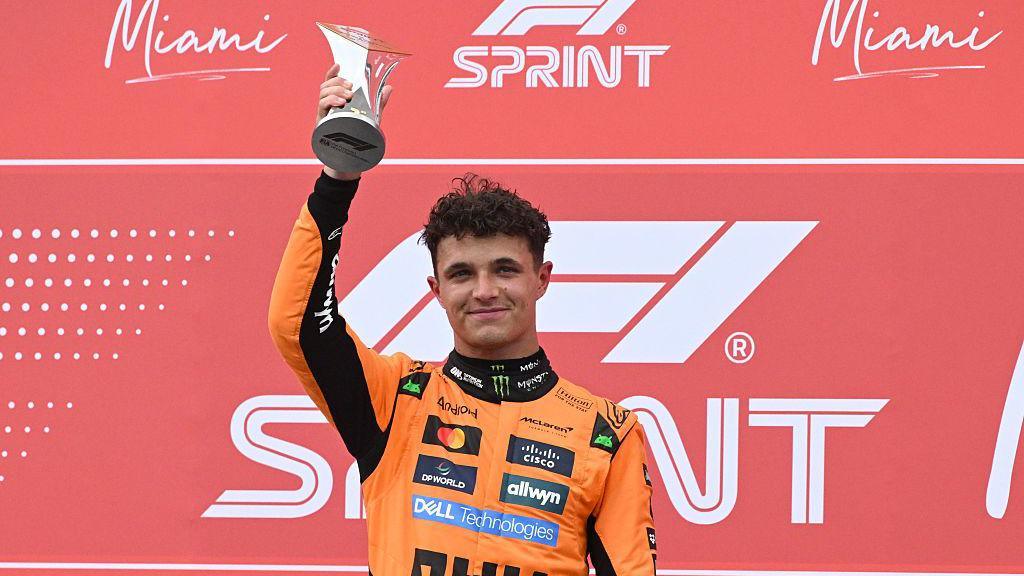 Lando Norris holds his sprint race trophy