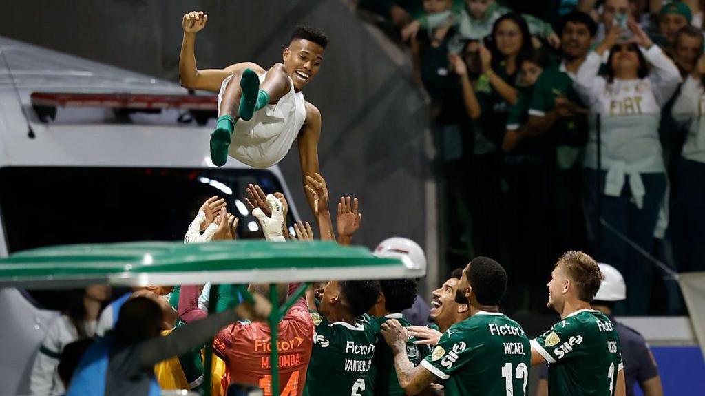 Palmeiras players throw Estevao Willian into the air in celebration