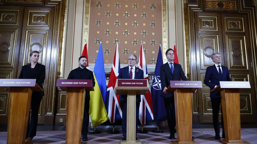 Starmer and European leaders stand in a row behind wooden lecterns 