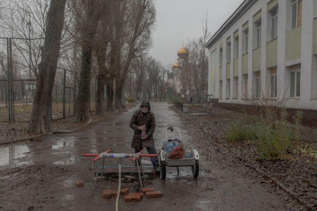 A local resident fills bottles with water in the Ukrainian city Pokrovsk, in the Donetsk region