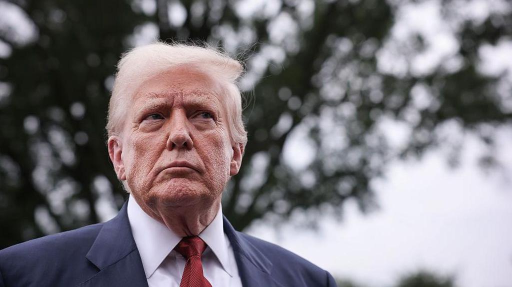 A headshot of President Trump looking serious