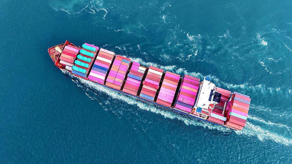 A cargo ship fully loaded with foreign trade containers leaves the port of Qingdao in Qingdao City, Shandong Province, China, on June 23, 2025