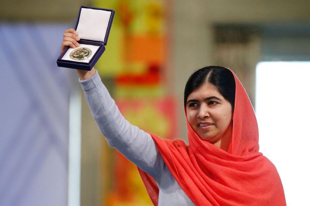 Malala holding up a Nobel Peace Prize.