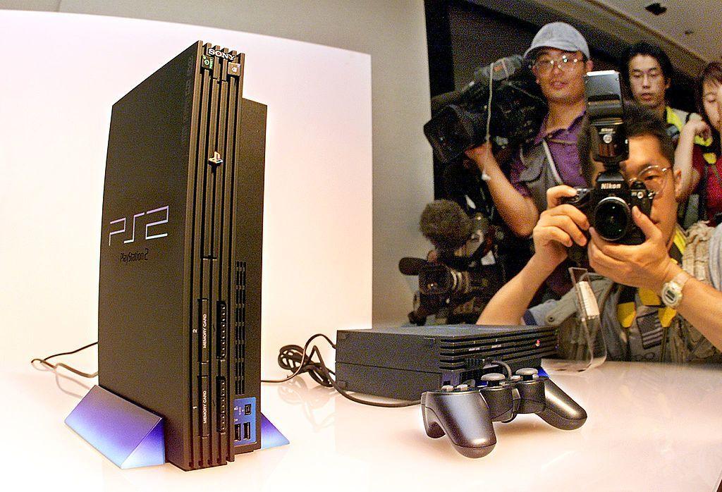 People taking pictures of the Playstation2. 