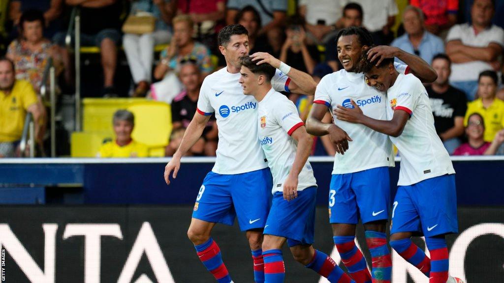 Robert Lewandowski celebrates scoring the winner with his Barcelona team-mates against Villarreal