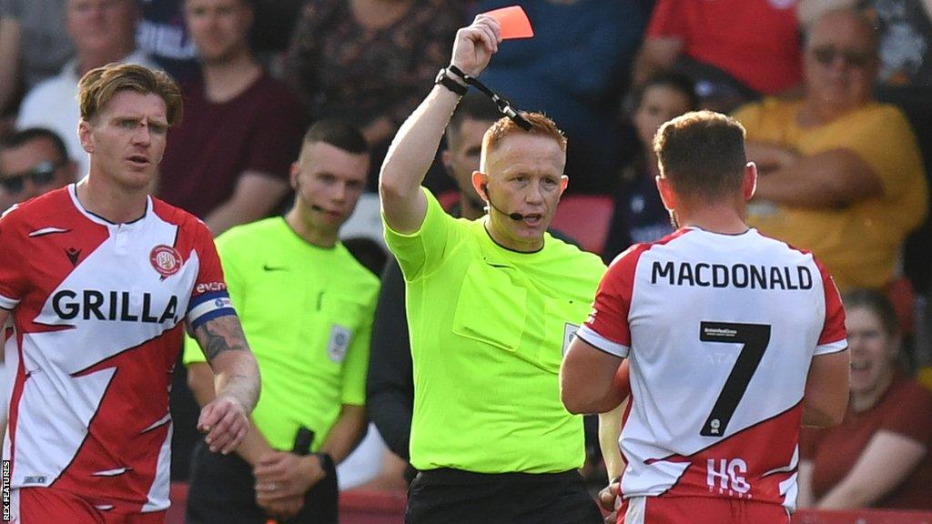 Stevenage's Alex MacDonald is shown a red card in their game against Wigan Athletic in League One on 7 October