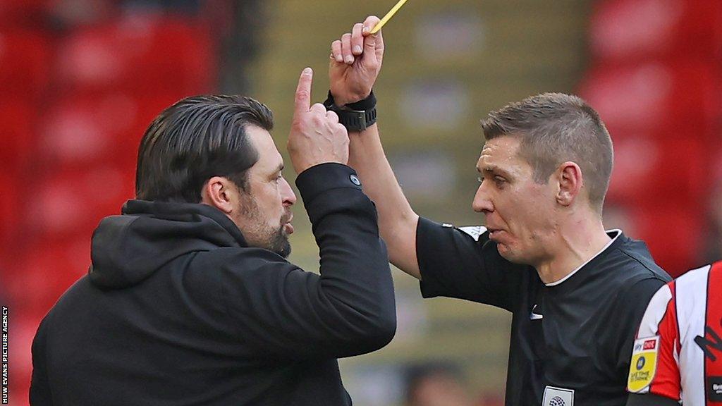 Russell Martin is booked for complaining about referee Matthew Donohue's decisions after 31 minutes