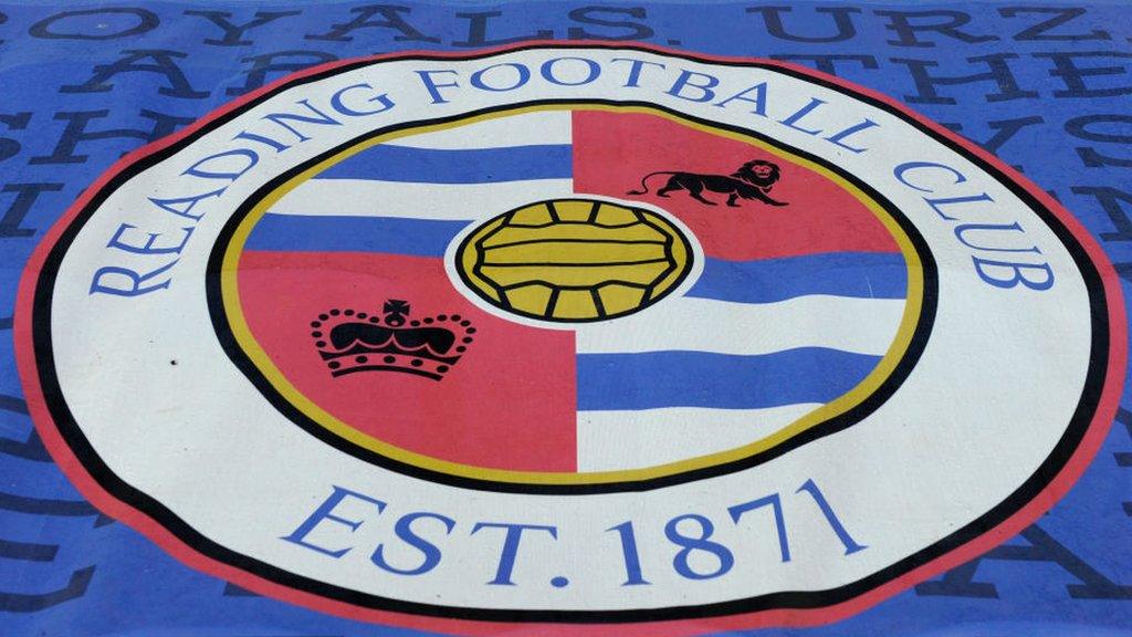 A Reading FC flag covers seats