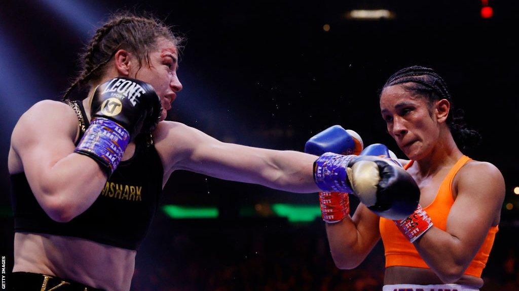 Katie Taylor aims a punch at Amanda Serrano