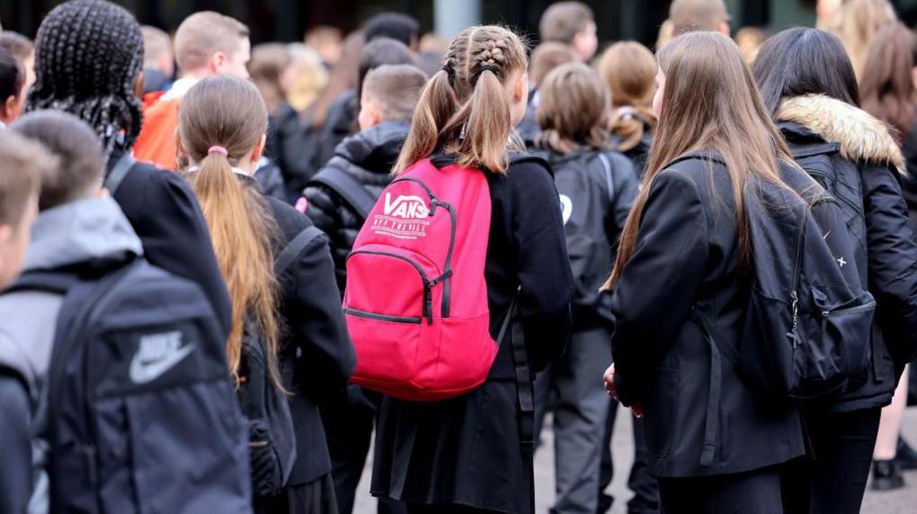 Pupils at St Paul's High School in Glasgow. A general view of high school pupils in the playground of the school, waiting to start the day.
