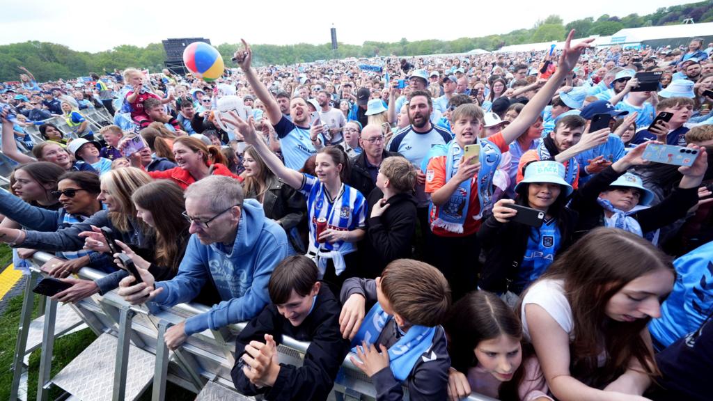 Coventry City fans cheering and singing at the music festival