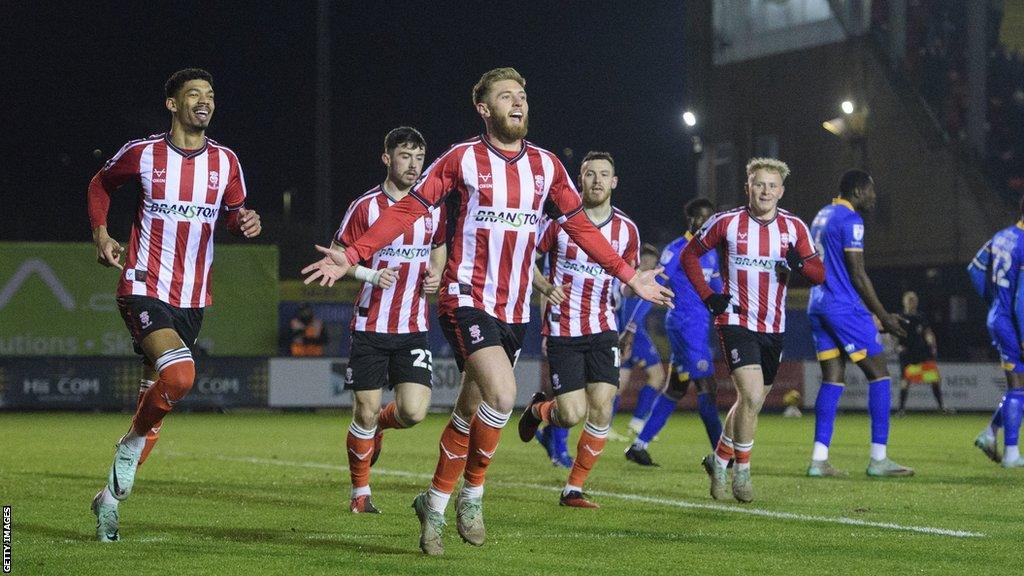 Ted Bishop celebrates a goal for Lincoln against Shrewsbury