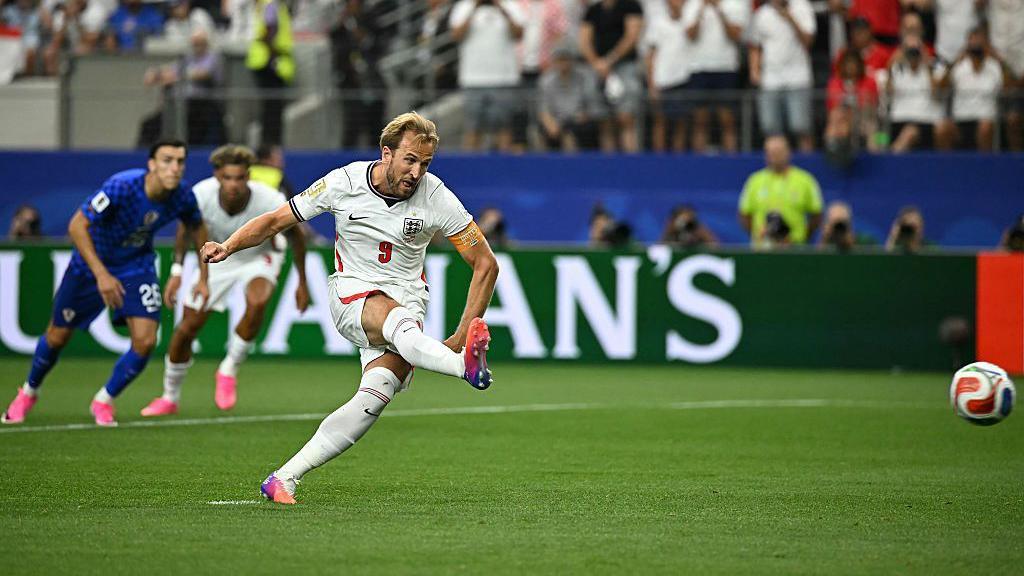 Harry Kane shoots and scores a retaken penalty kick.